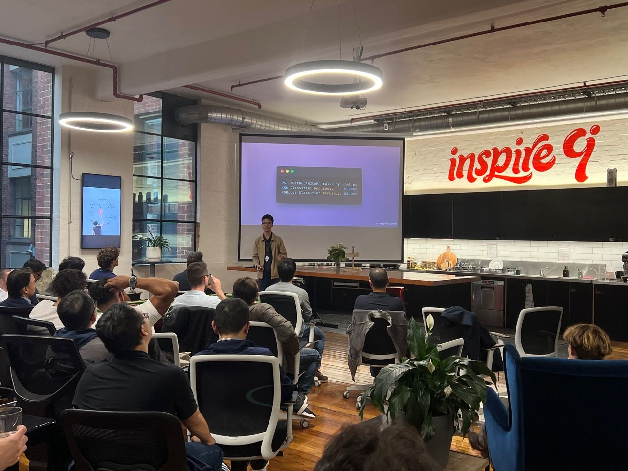 Alan speaking to the audience at AICamp Melbourne